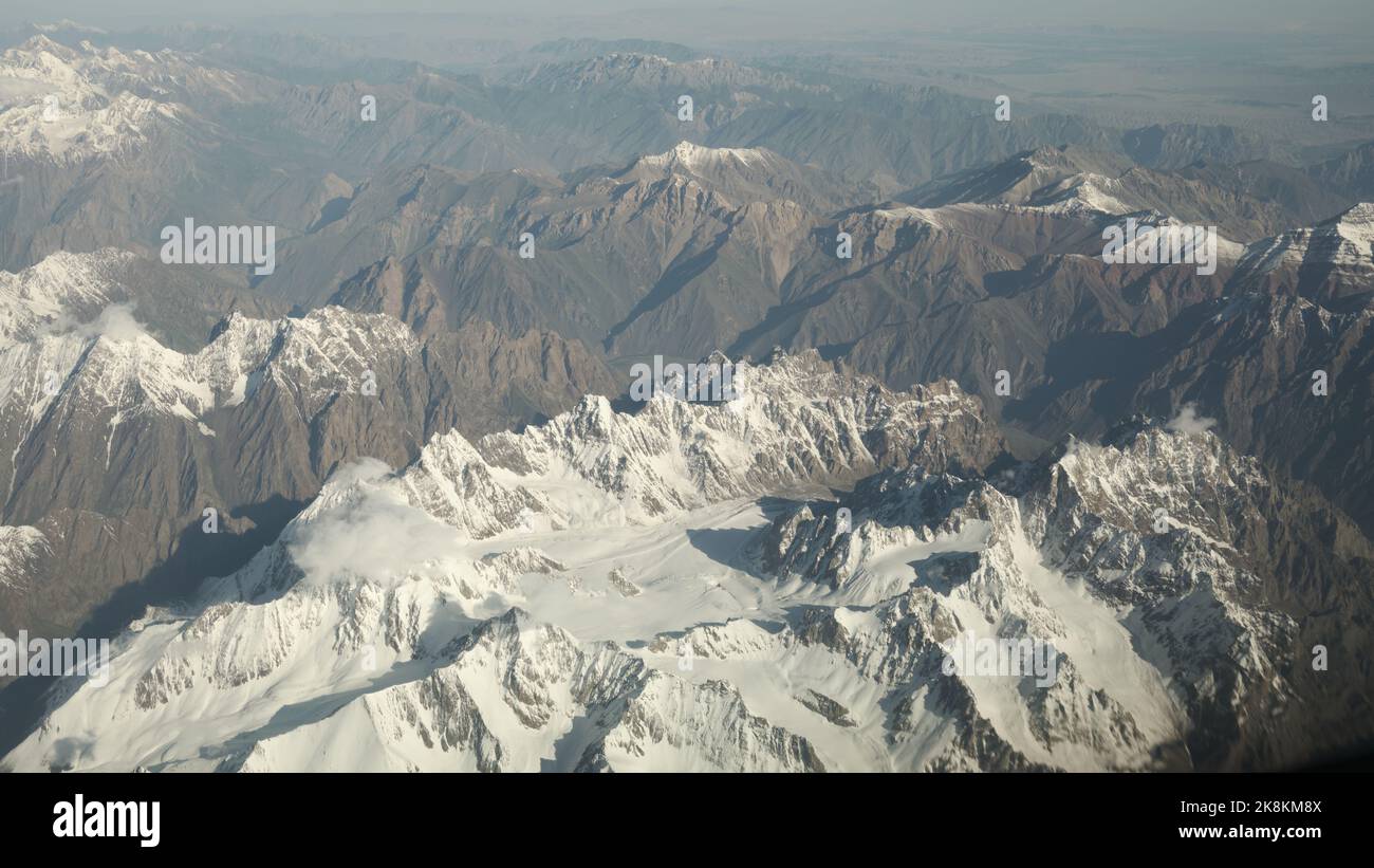 An aerial view of snowcap rocky mountain peaks Stock Photo - Alamy
