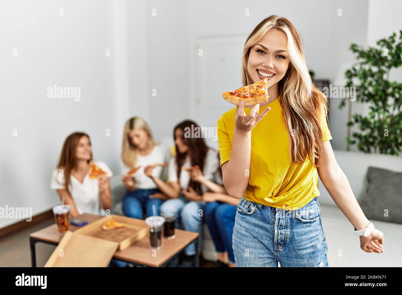 Group of young woman friends smiling happy eating pizza at home Stock ...