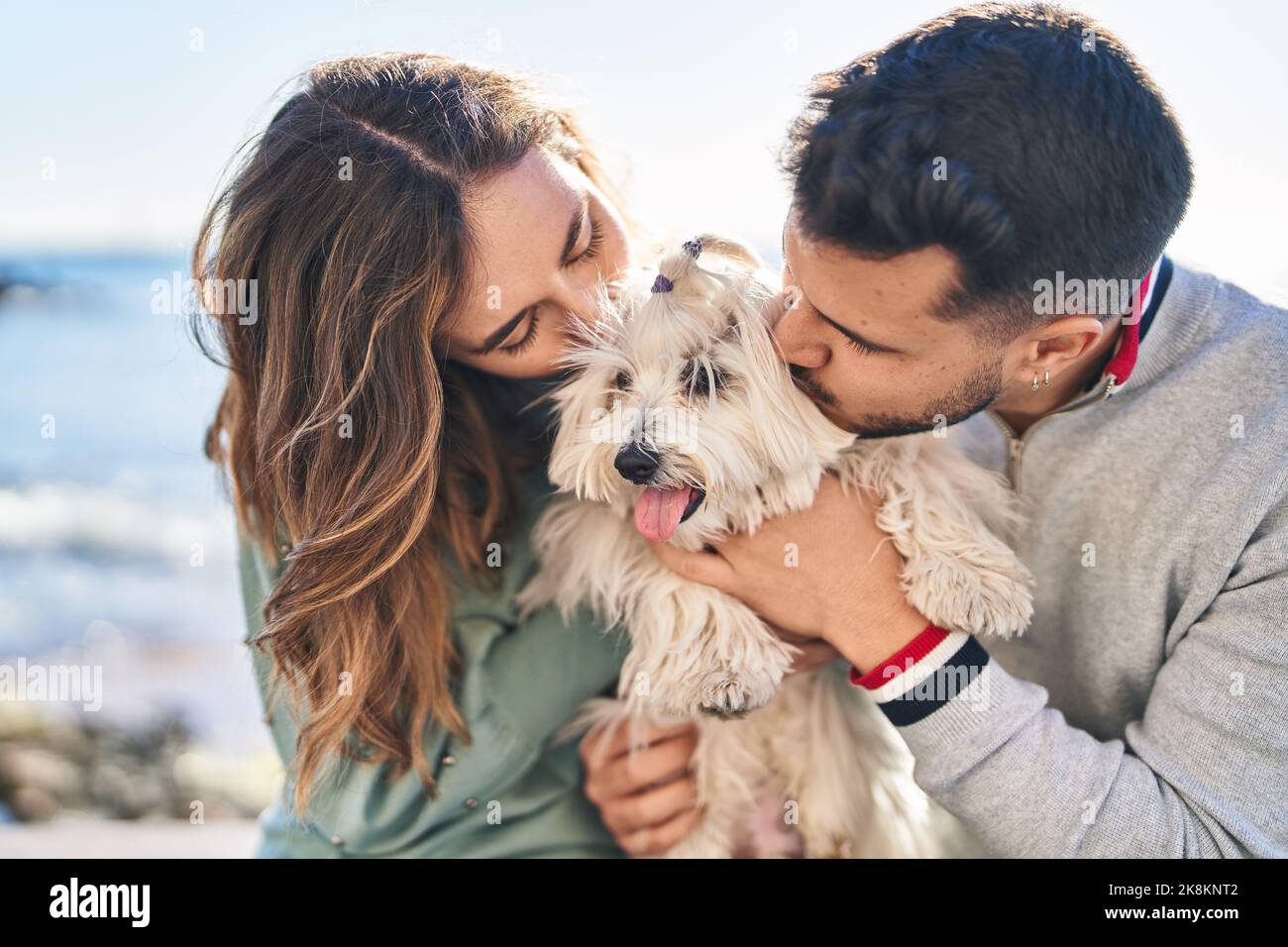 Young couple kissing hugging dog hi-res stock photography and images ...