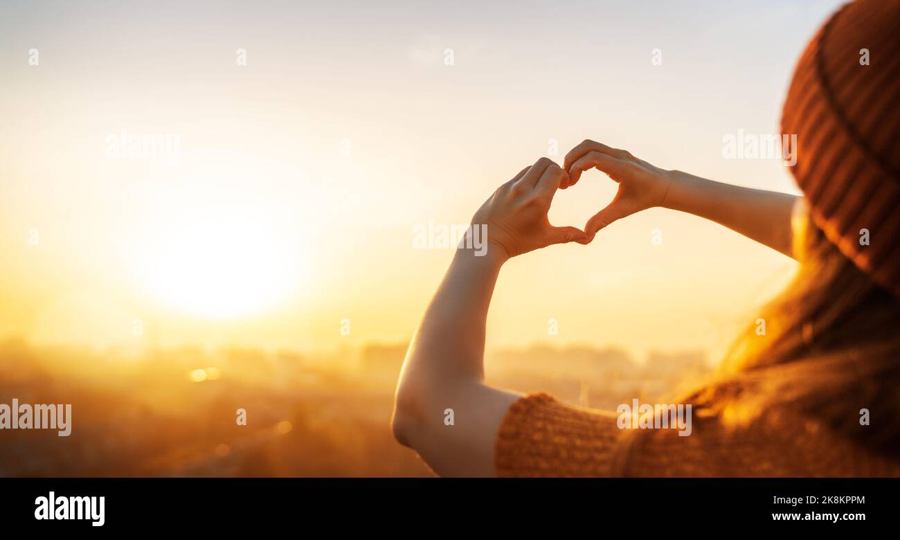 Female hands in the form of heart against the sunset sky Stock Photo ...