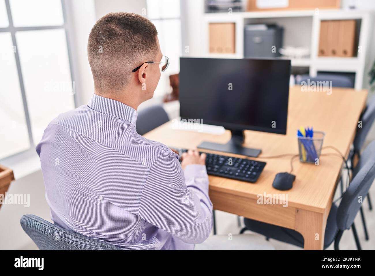 Hispanic Man Using Computer Young hispanic man business worker using computer working at office ...