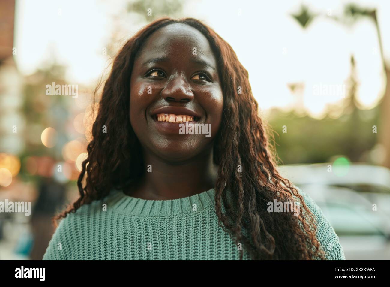 Young african woman smiling happy at the city Stock Photo - Alamy