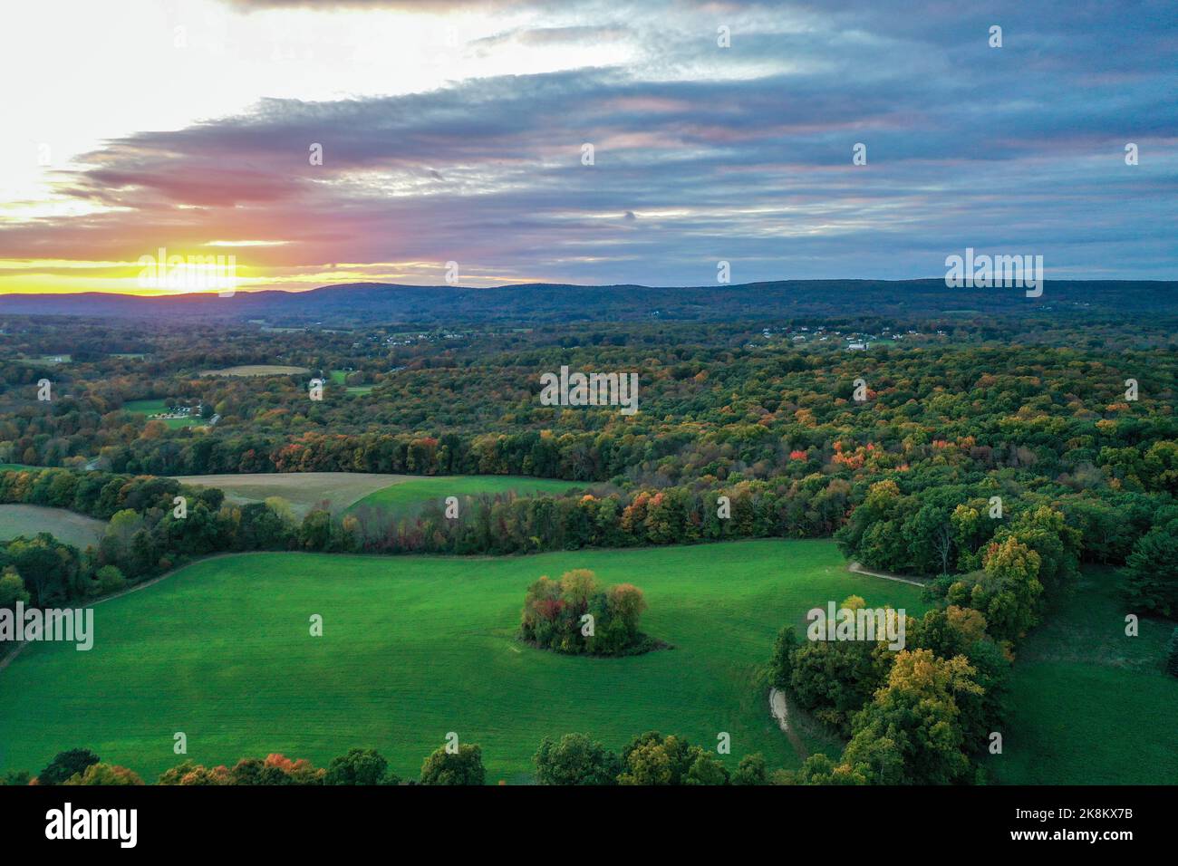 Brilliant Sunset in early fall over Sussex County NJ with large fields and foliage aerial Stock Photo