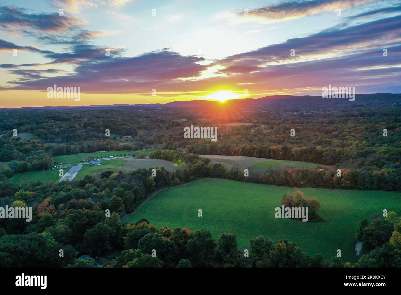 Brilliant Sunset in early fall over Sussex County NJ with large fields and foliage aerial Stock Photo