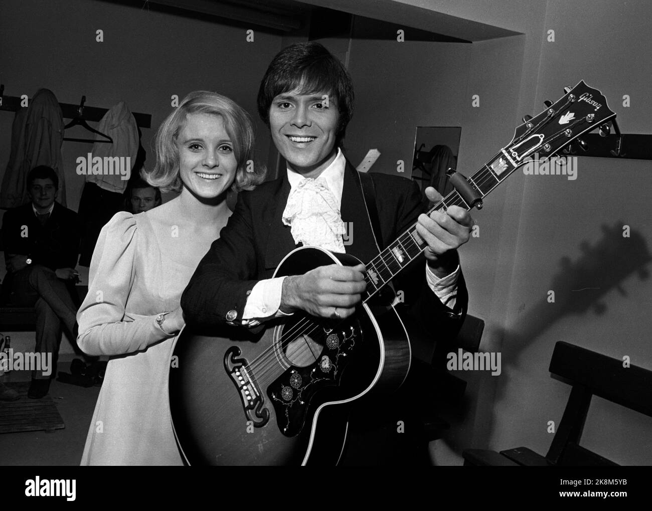 Oslo 19691125 Artist Cliff Richard visits Norway. Here Cliff Richard with guitar and with Ingunn Hjort. Photo: NTB / NTB Stock Photo