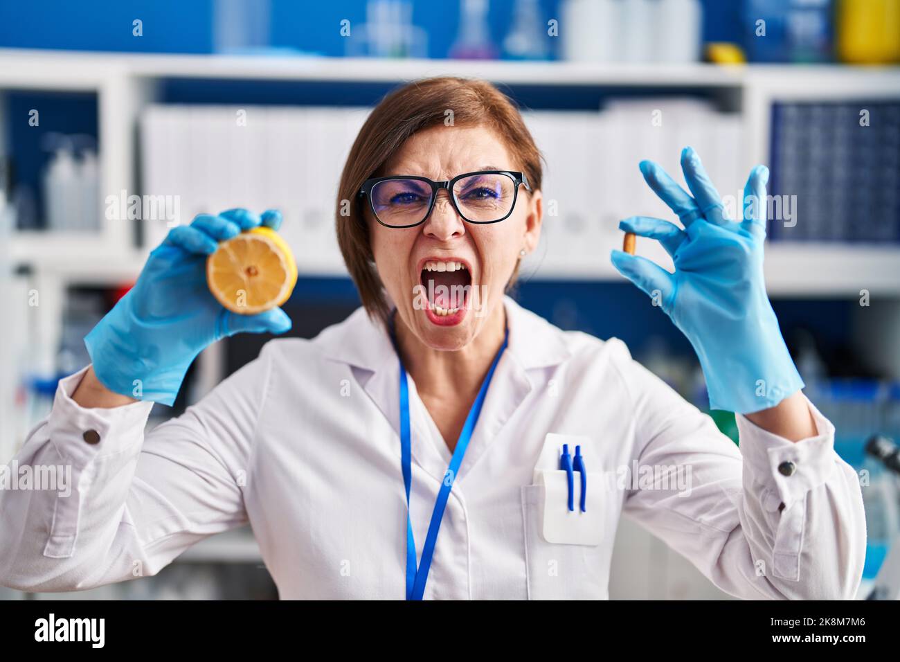 Middle age hispanic woman working at scientist laboratory making ...