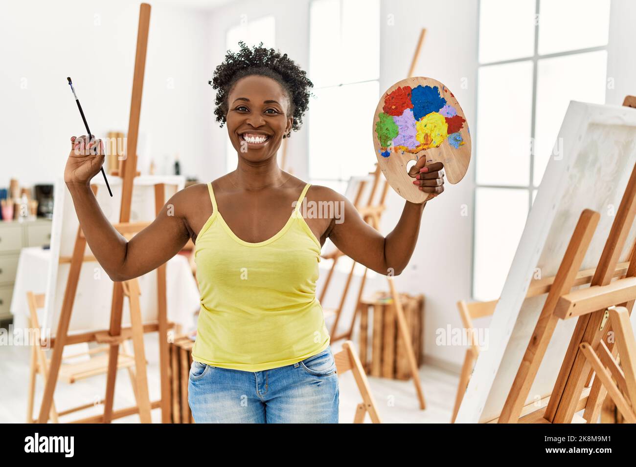 Young african american artist woman smiling happy drawing at art studio ...