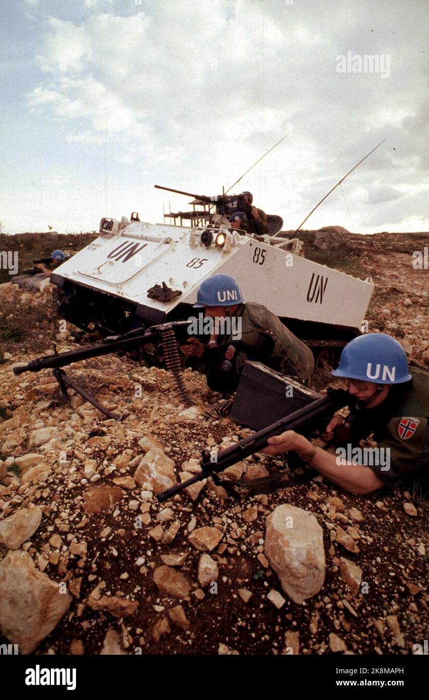 Lebanon 1988. Norwegian UN soldiers in Lebanon are on guard with firearms, right by a reinforced vehicle. Flag on the uniform. UNIFIL force. Scan photo: Odd Steinar Tøllefsen / NTB Stock Photo