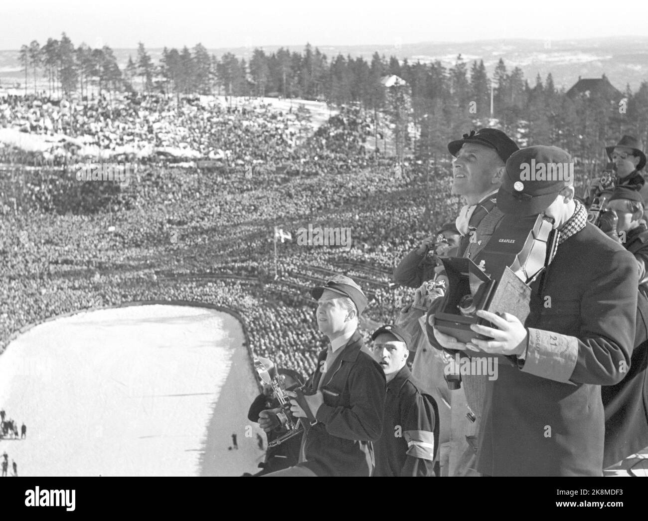 Holmenkollen, Oslo 19500318. Jumping in Holmenkollbakken. The wind was blowing away the entire Holmenkollrennet, but after three hours of postponement it quieted off. 90,000 spectators in the stands and at Sletta were present. Here we see press photographers in the jump hill who will photograph the events. Photo: Sverre A. Børretzen / Current / NTB Stock Photo