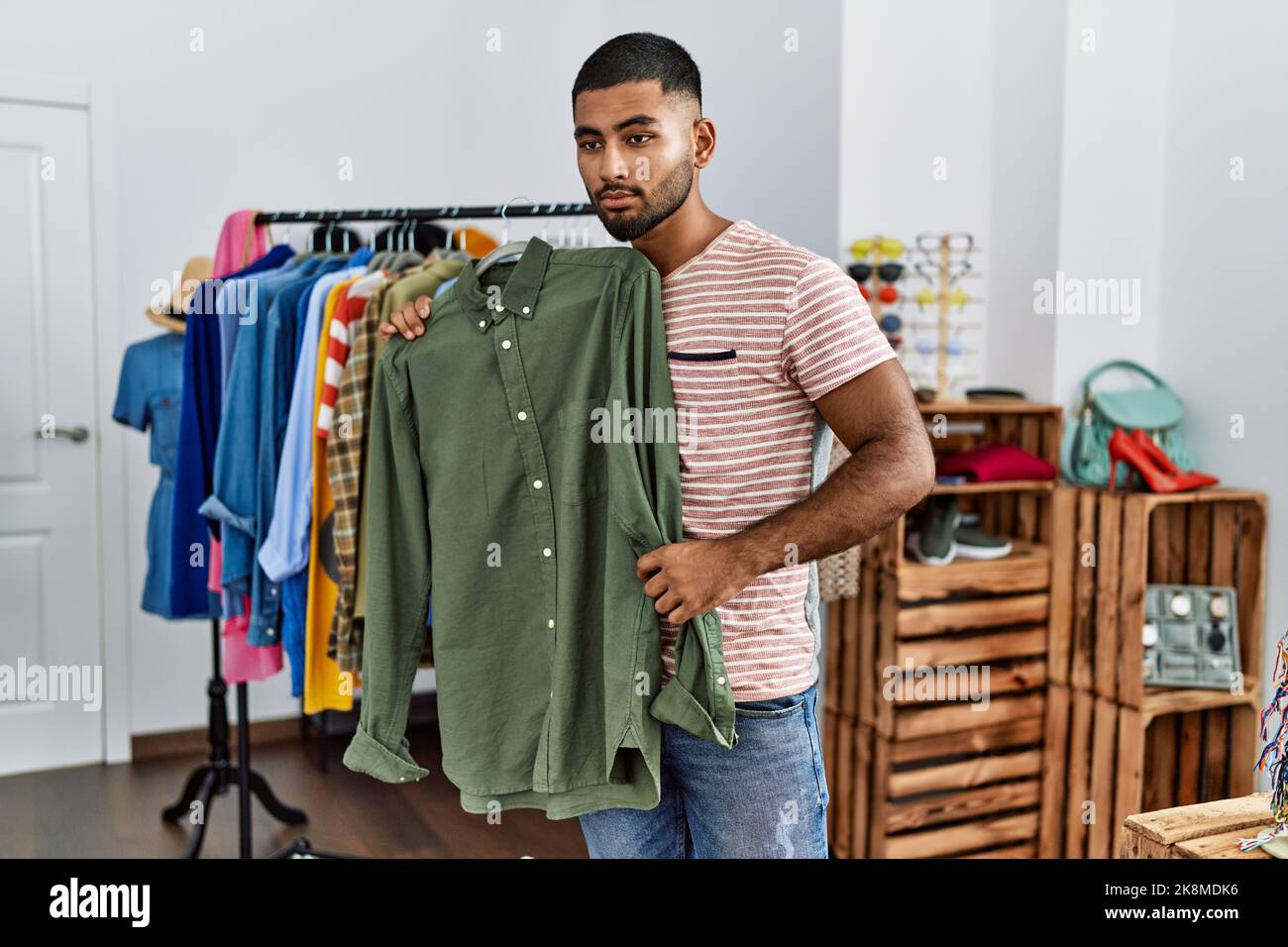 Young arab man shopping at clothing store Stock Photo - Alamy