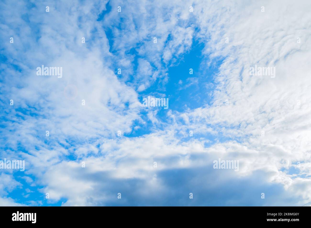 Blue sky background, dramatic vast blue sky landscape scene, panoramic sky scene with scenic white clouds Stock Photo