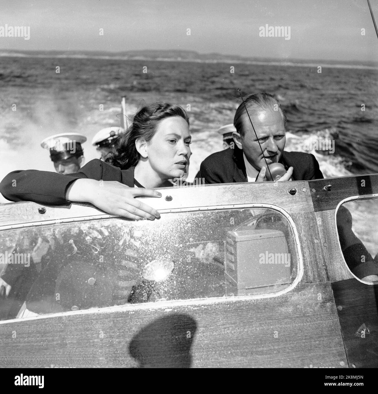 Hankø in the summer of 1956. Recording Norway's first feature film in color, titled 'Smugglers in tuxedo'. Here 'Police Officer Reidar Nissen' played by Carsten Byhring, who is hunting for the big smugglers in a boat belonging to the Customs Service, Anne Lise Tangstad (who plays Eva). Both the Swedish and Norwegian Customs Service agreed to join the film. Photo: Aage Storløkken / Current / NTB. Stock Photo