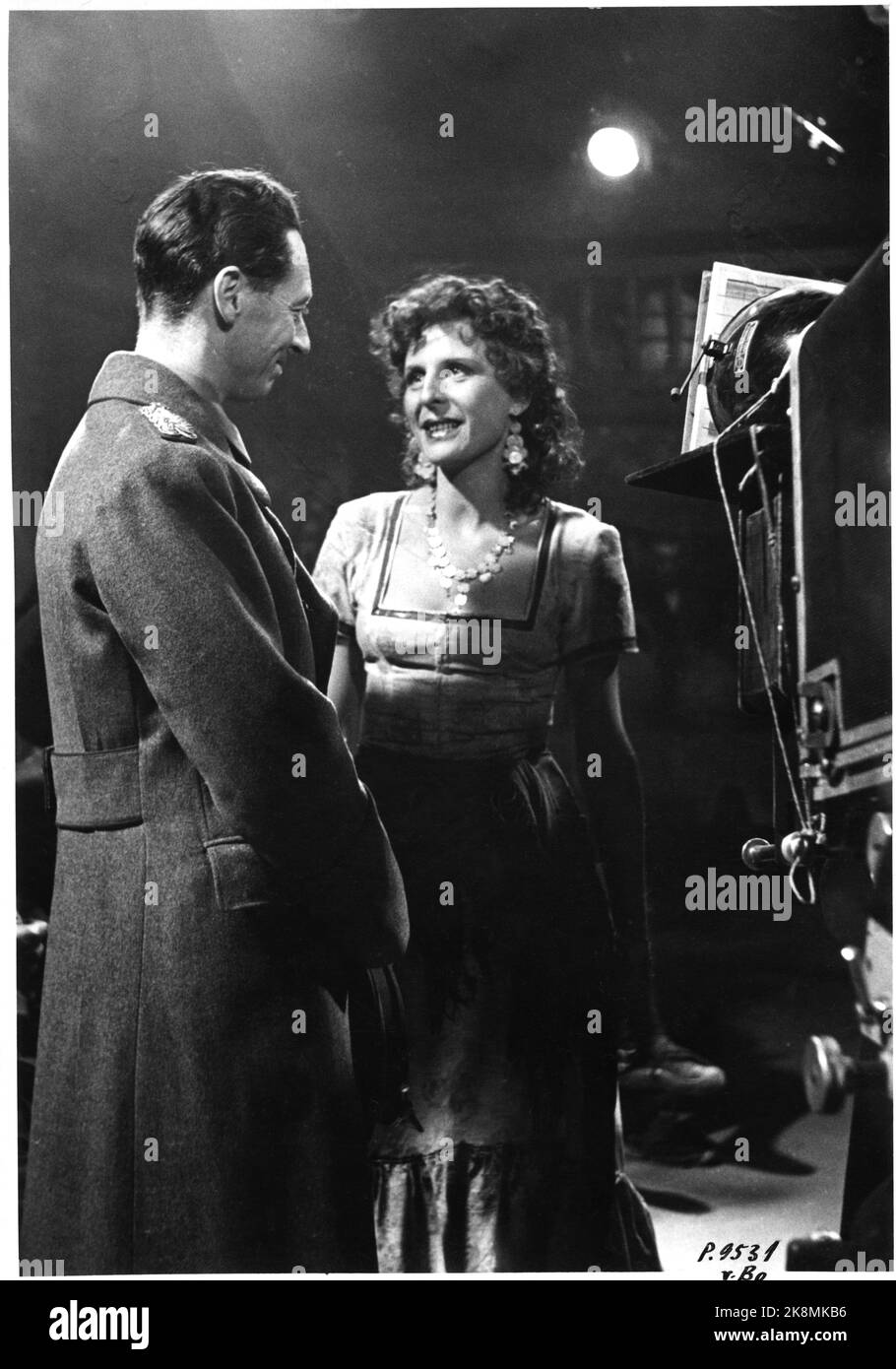 Germany? 19420422 The famous actress and stage setter, Leni Riefenstahl in conversation with Minister Gulbrand Lunde during filming in an UFA-Atelier. Photo: NTB Stock Photo
