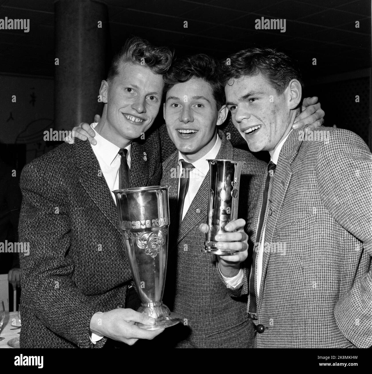 Oslo 19601030 Soccer. The cup final Rosenborg - Odd, 3-2 after extra rounds, Ullevaal Stadium. The first match ended 3-3. In the picture, Rosenborg celebrates the victory. The team became Norwegian champions for the first time, and it was also the first time that a team north of Dovre won the cup. The picture shows: Birger Thingstad, Kåre Rønnes and Eldar Hansen with the King's Cup. Ntb archive photo / ntb Stock Photo