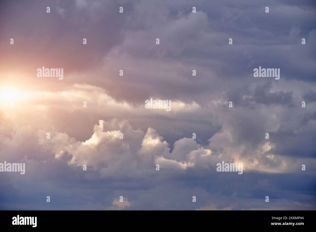 Breaking sunlight through gap of storm clouds Stock Photo