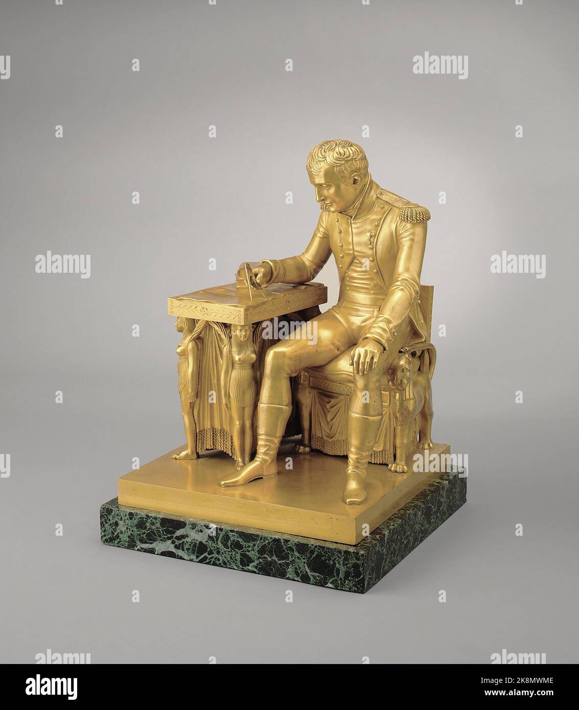 Antoine Mouton, known as Moutoni (born in 1765) French school Napoleon I studying a map of Europe Chiselled bronze painted gold with green marble base (H. 46.5 cm x L. 33 cm x D. 33 cm) Statuette created by Vivant Denon commissioned by Napoleon for his workroom in the Tuileries Palace.  Alberto Ricci Photo Stock Photo