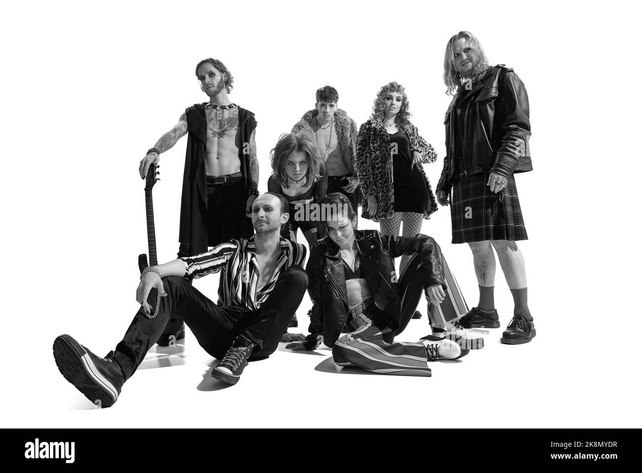 Group of stylish people, man and woman, rock music performers posing. Black and white photography. 50s culture Stock Photo