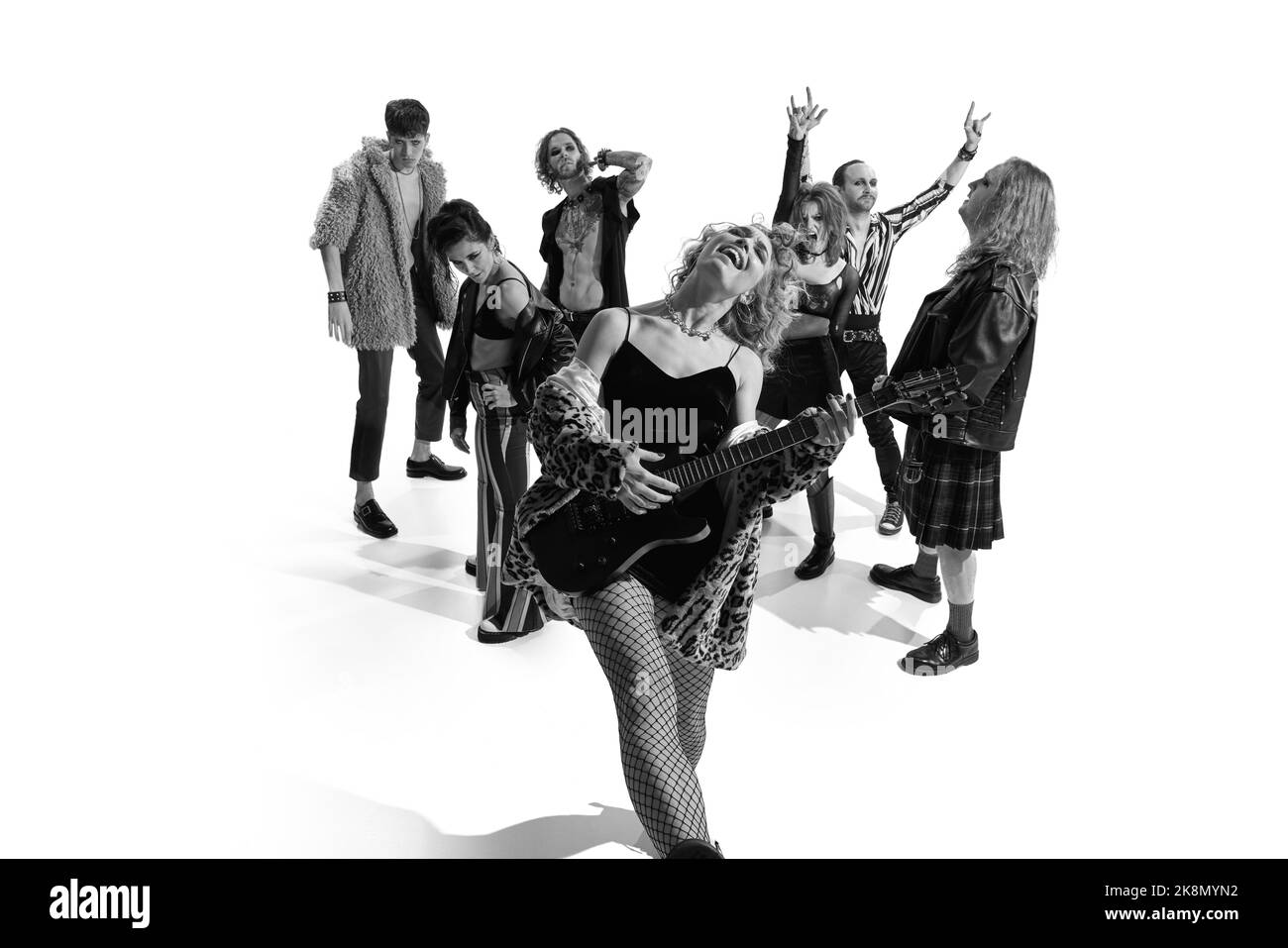 Group of stylish people, man and woman, performing. Rock and roll era ...