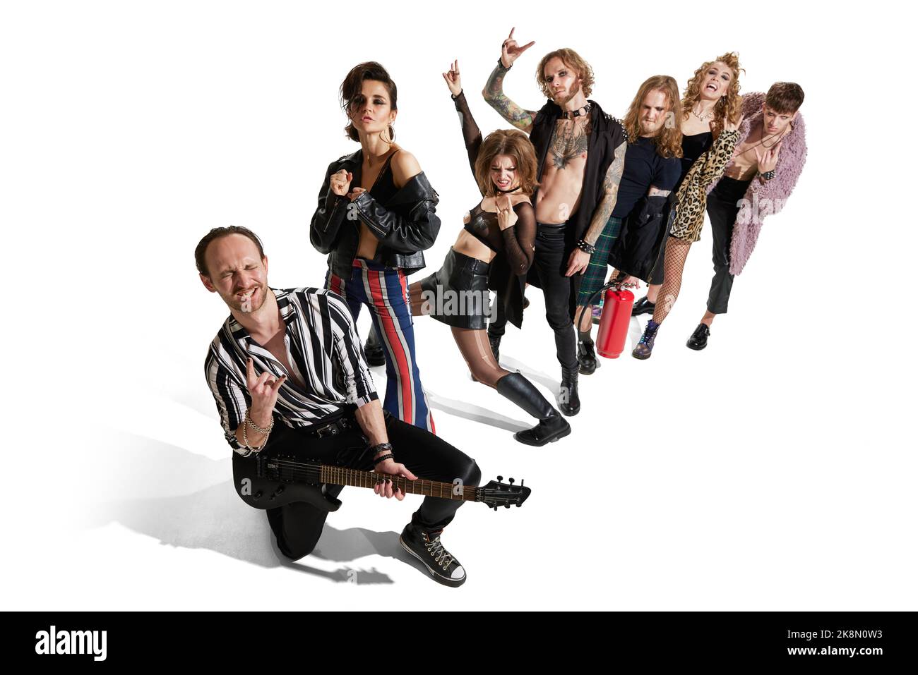 Group of stylish people, man and woman, rock music performers posing