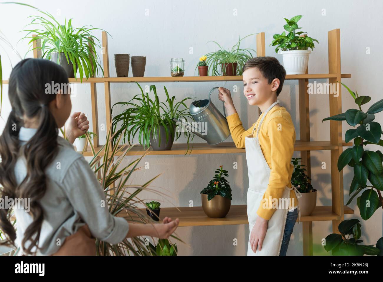 Girl and boy watering plants hi-res stock photography and images - Alamy