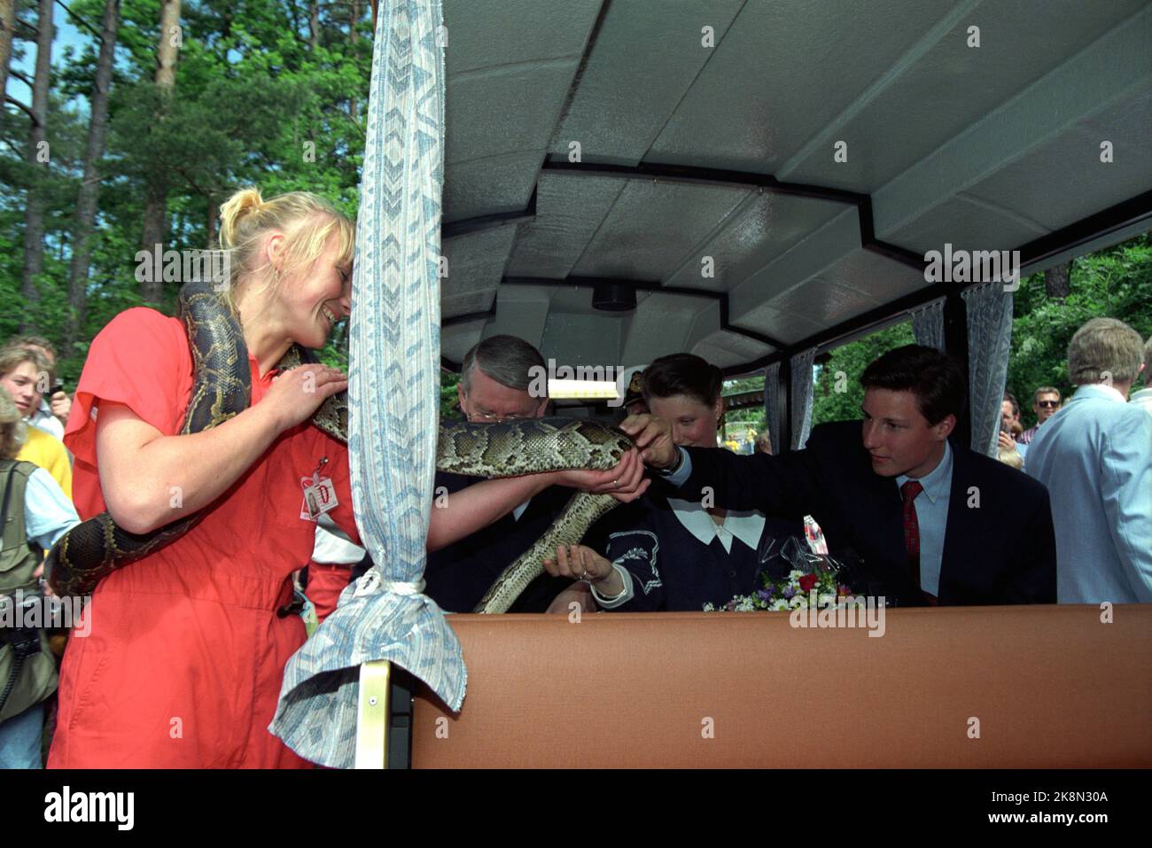 Kristiansand 19910627 - June 1991. The royal family in Kristiansand. Visiting the Zoo. Here they greet a python hose, tiger python. Crown Prince Haakon and Princess Märtha Louise clap the snake. Photo: Lise Åserud / NTB Stock Photo