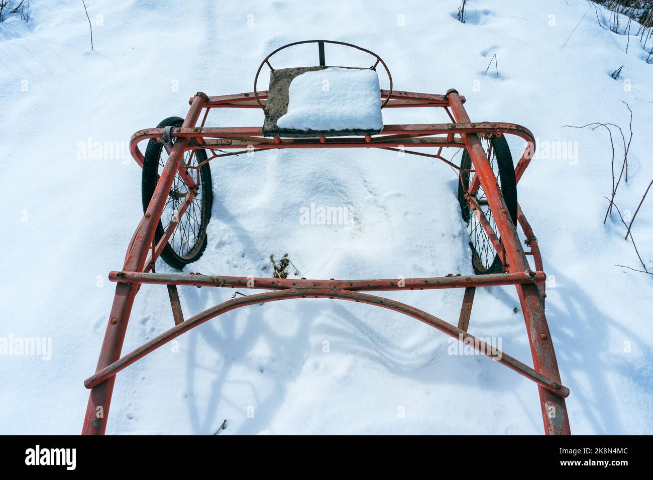 red wooden sulky in the snow Stock Photo