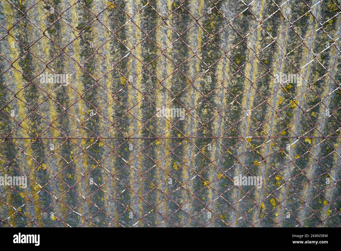 Metal wire mesh fence with plastic in front Stock Photo - Alamy