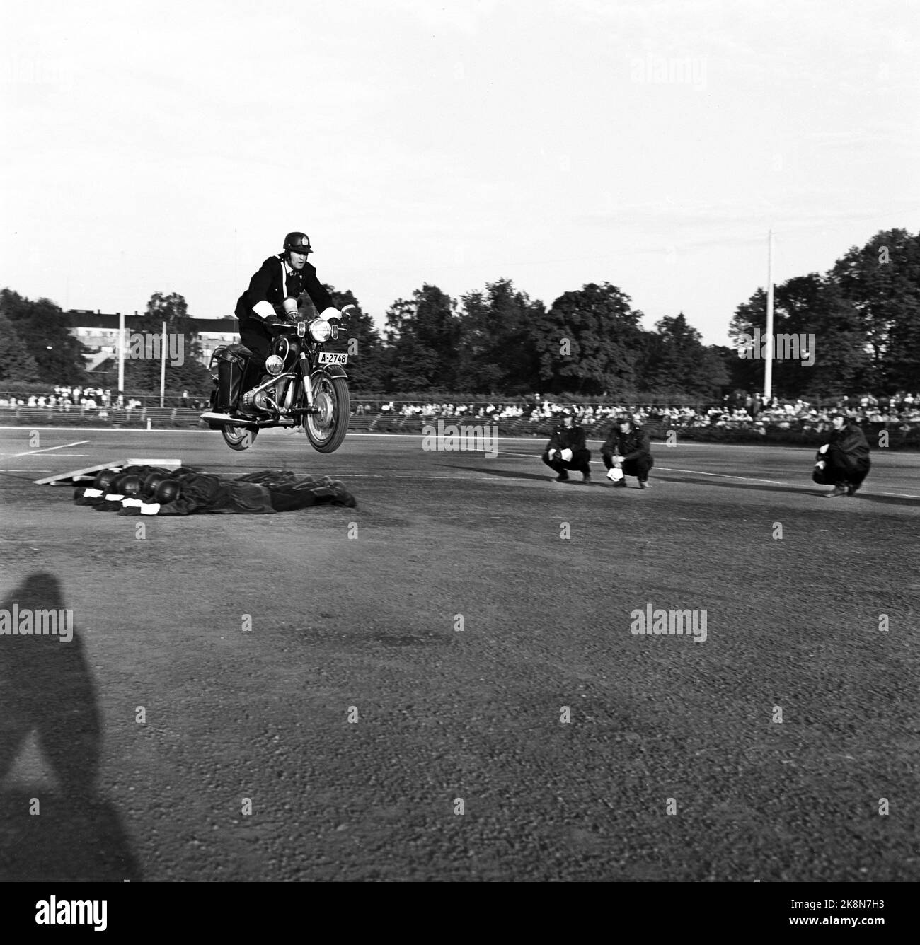 Oslo 19630607. Police Day at Frogner Stadium. Here motorcycle shows. Led by police officer L. Føsker. Jumps on motorcycle over reclining officers. Photo: Erik Thorberg / NTB / NTB Stock Photo