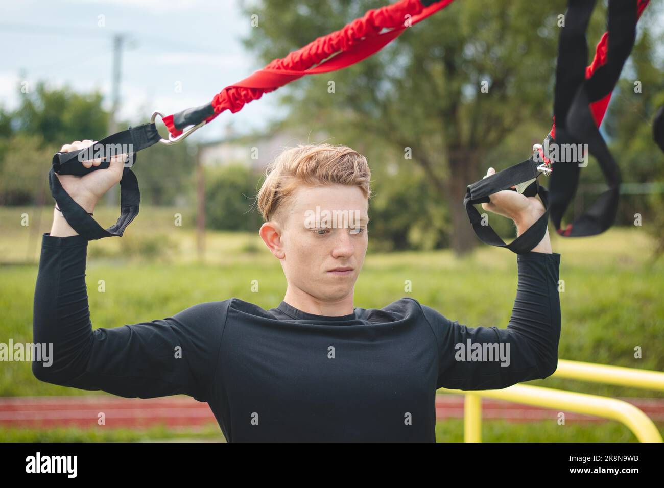 Professional athlete stretches and strengthens his arms, shoulders and