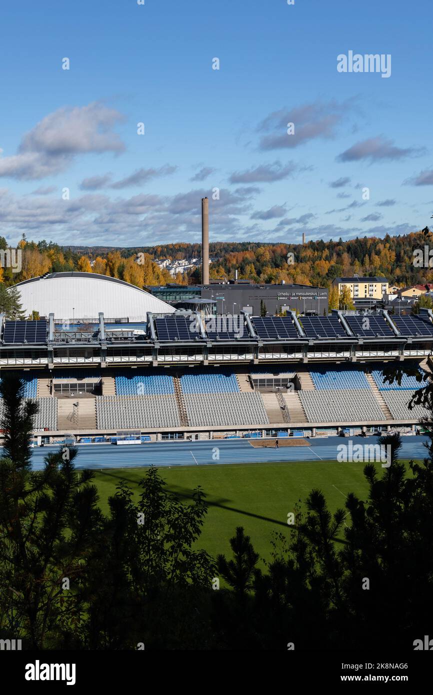 Lahti, Finland. October 9, 2022. Lahti Stadium stands seen from between the trees in autumn Stock Photo