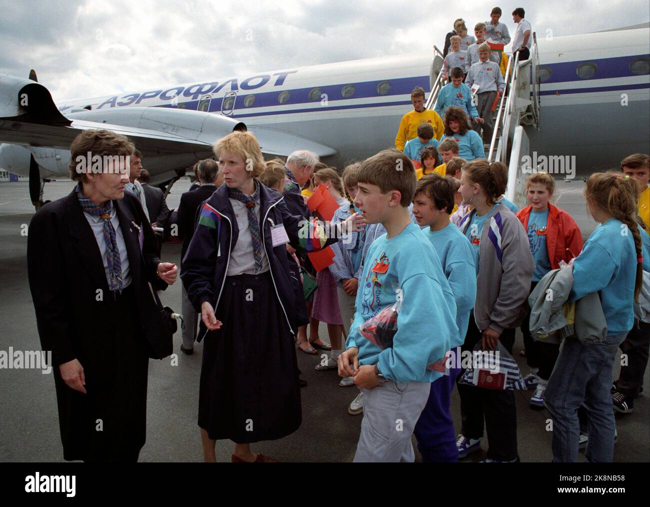 Oslo June 17, 1991. Children from Chernobyl are in Oslo to breathe radioactive-free air. Here from Fornebu when they leave the Aeroflot aircraft. Bjørg Walstad (t.v.) and Bodil Tærud receive Chernobyl children. The Norwegian Scout Association is hosts for the children who will be in Norway for 1 month. Photo: Morten Hvaal / NTB / NTB Stock Photo