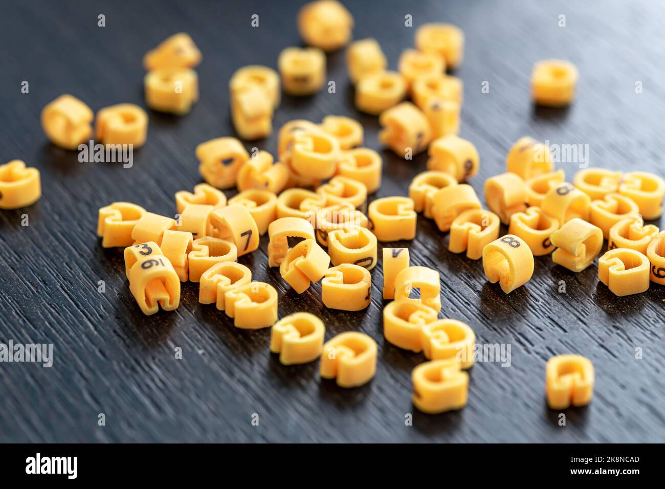 Cable markers scattered on the table, macro shot. Stock Photo