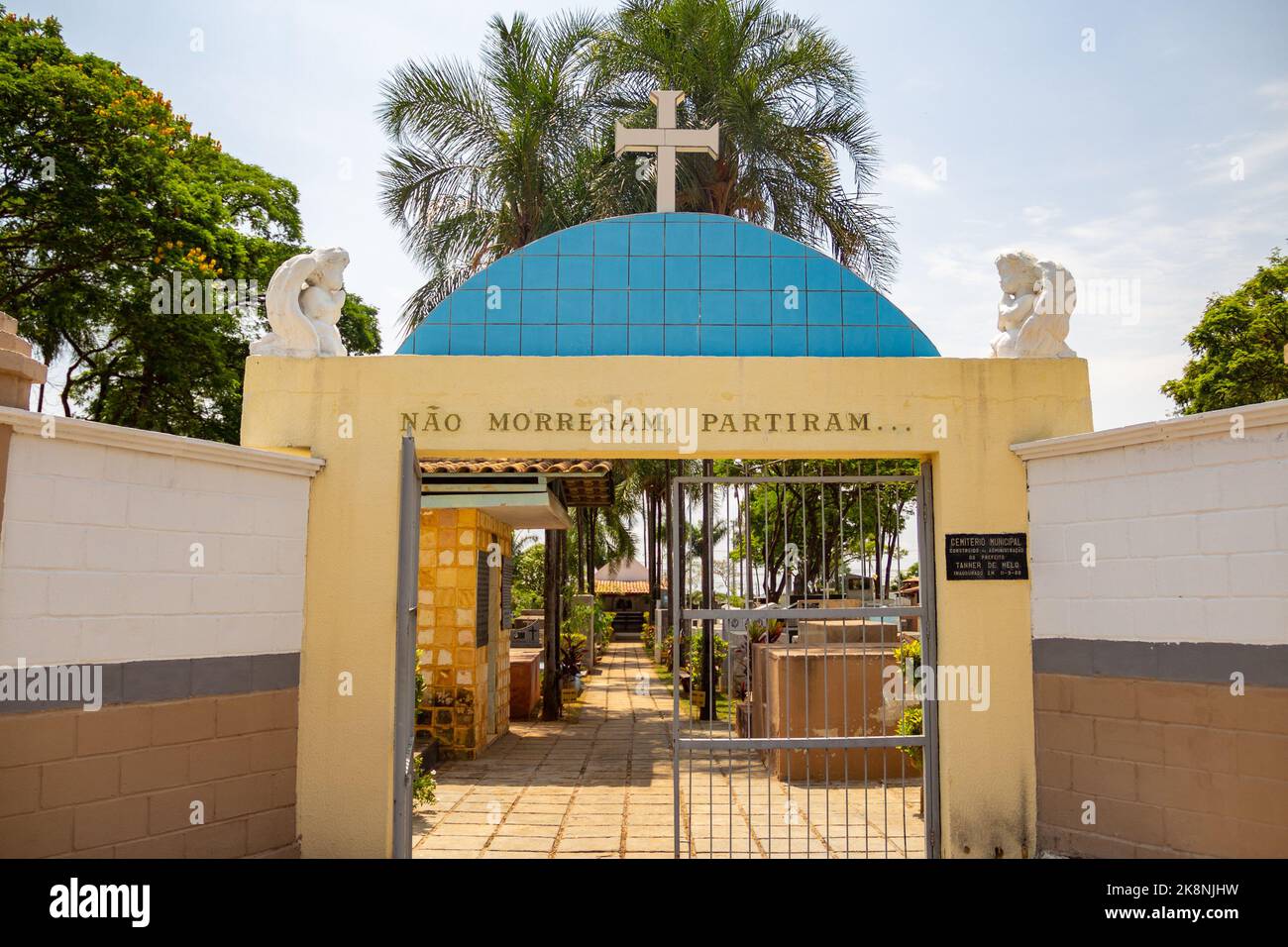 Aparecida de Goiânia, Goias, Brazil – October 23, 2022: Entrance gate to a cemetery with a white cross on top. Stock Photo