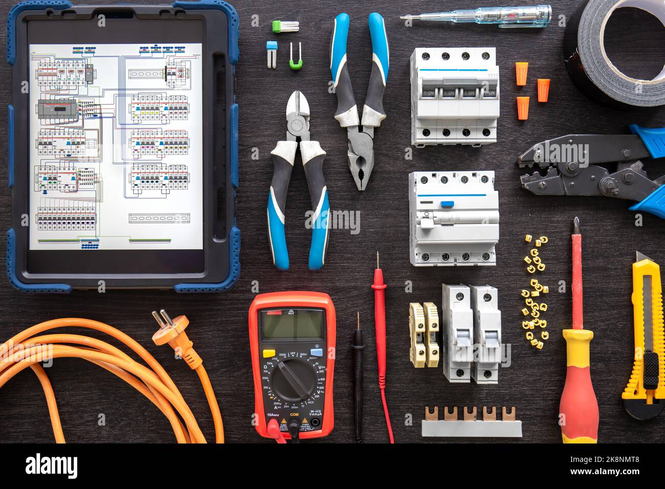 Different electrical tools on wooden background, flat lay. Stock Photo