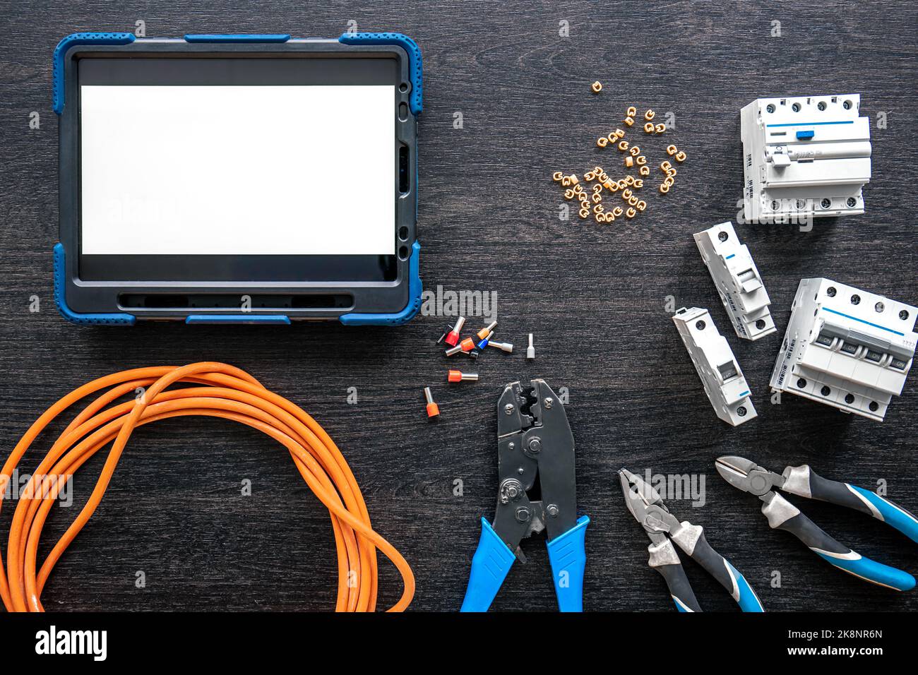 Different electrical tools and digital tablet on wooden background, flat lay. Stock Photo