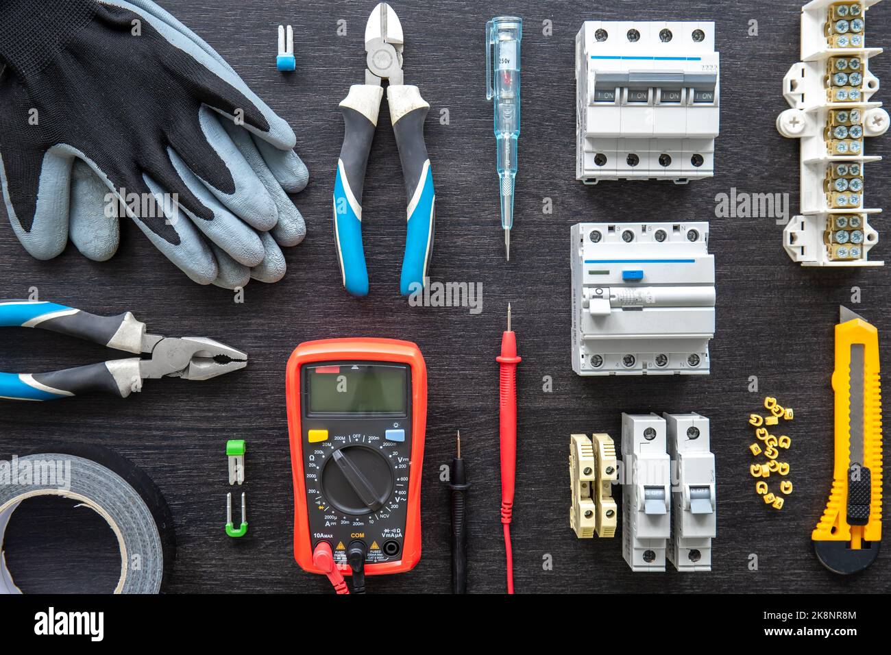 Different electrical tools on wooden background, flat lay. Stock Photo
