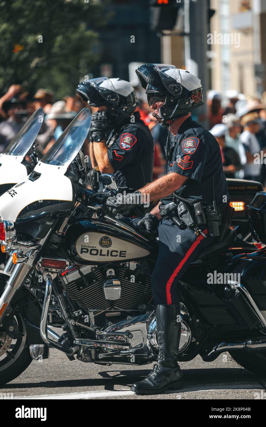 A vertical shot of police officers sitting on motorcycles at the ...