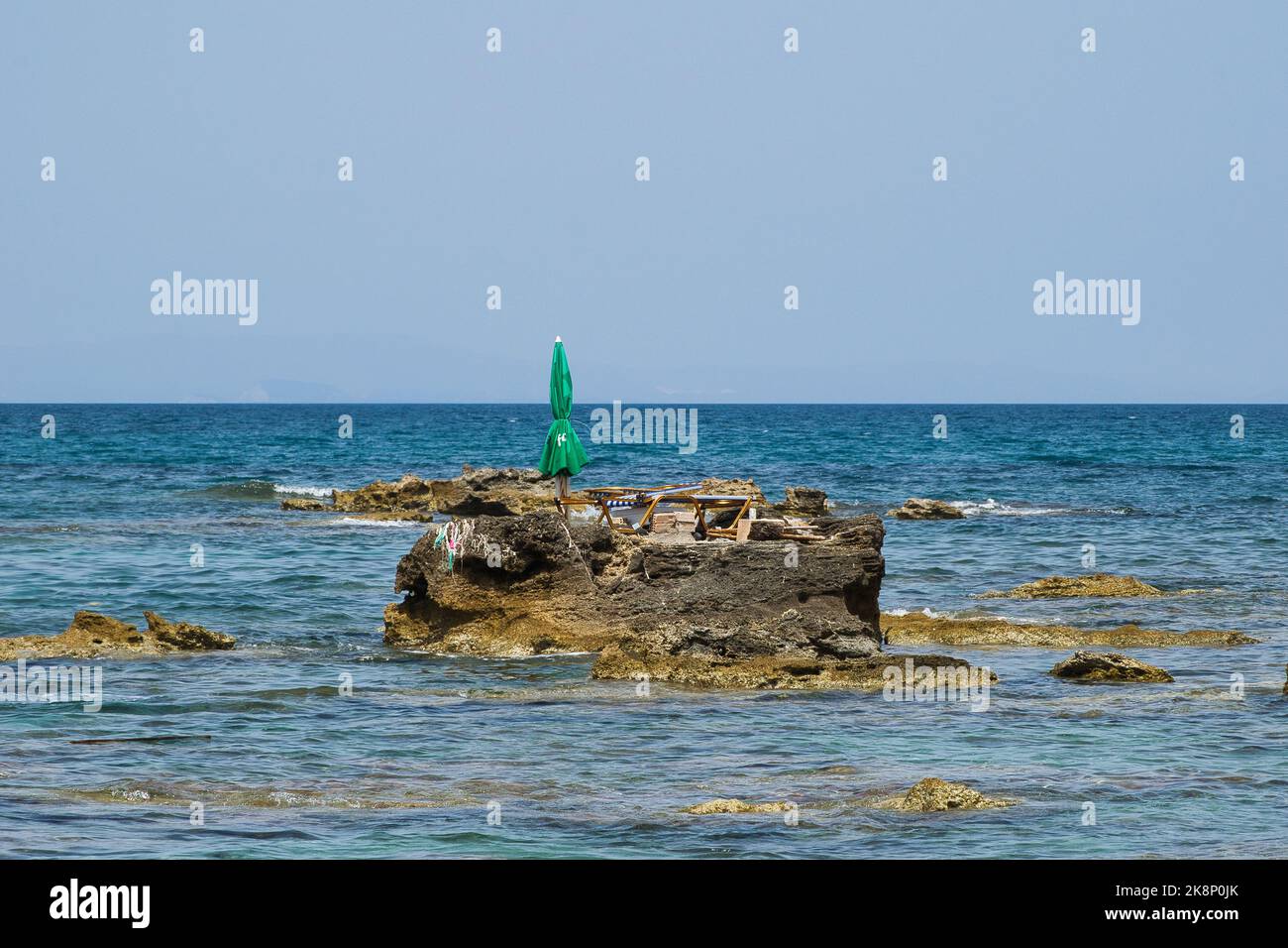 The smallest inhabited island in the world with one umbrella and one beach lounger Stock Photo