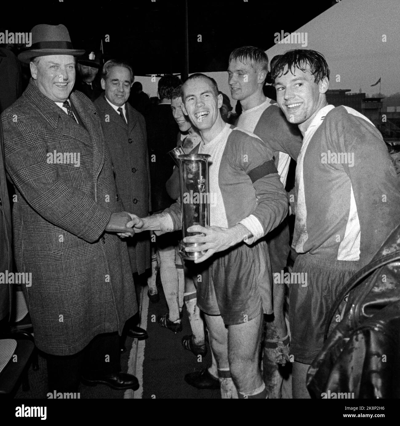 Oslo 19681027 The Lyn Football Club took 'The Double' in 1968. Here from the cup final, where Lyn beat Mjøndalen 3-0. Team captain Andreas Morisbak receives the King's Cup from a smiling King Olav. Photo: NTB / NTB Stock Photo