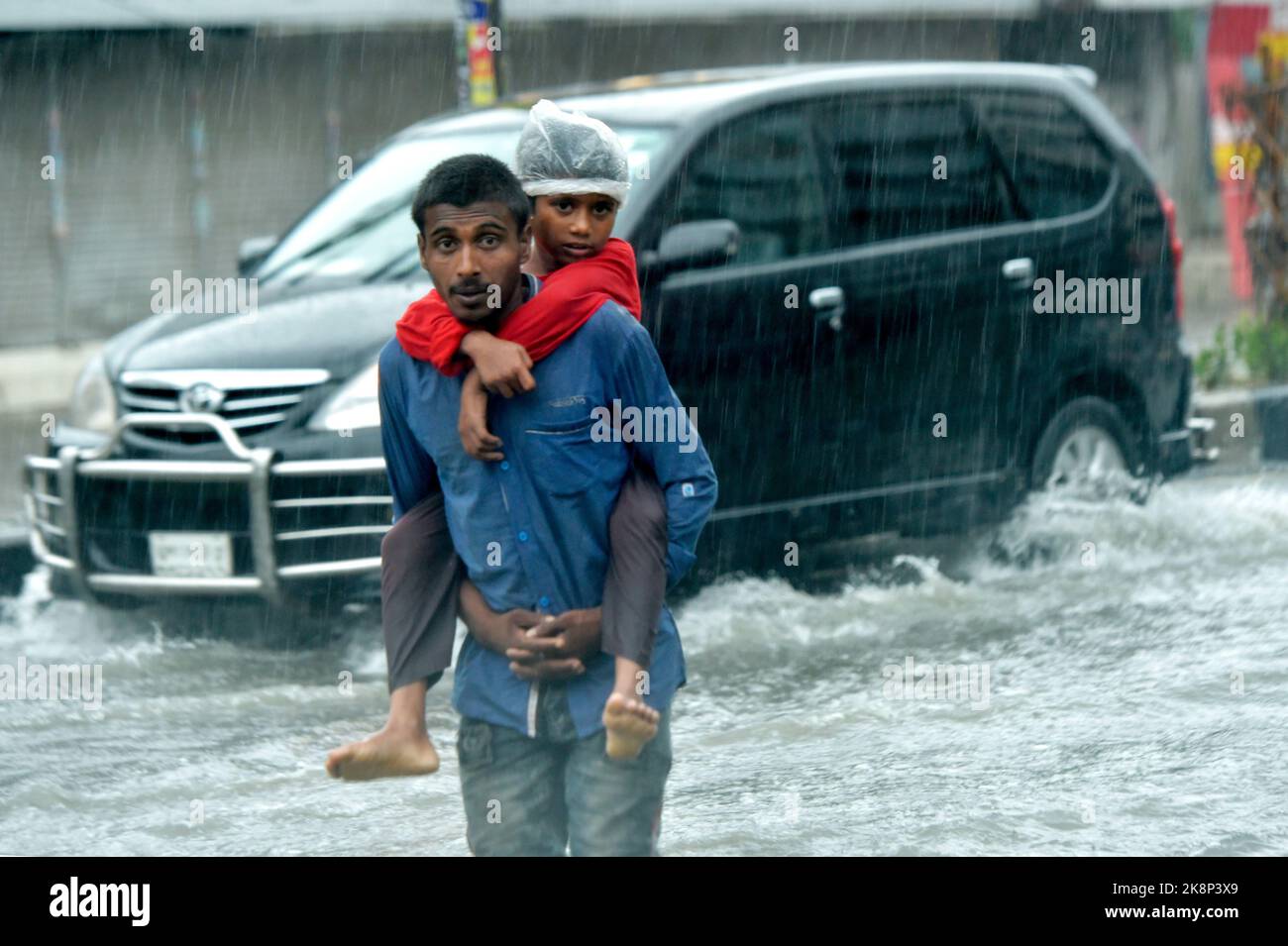 Dhaka 24th Oct 2022 People Walk On A Waterlogged Street In dhaka-24th-oct-2022-people-walk-on-a-waterlogged-street-in
