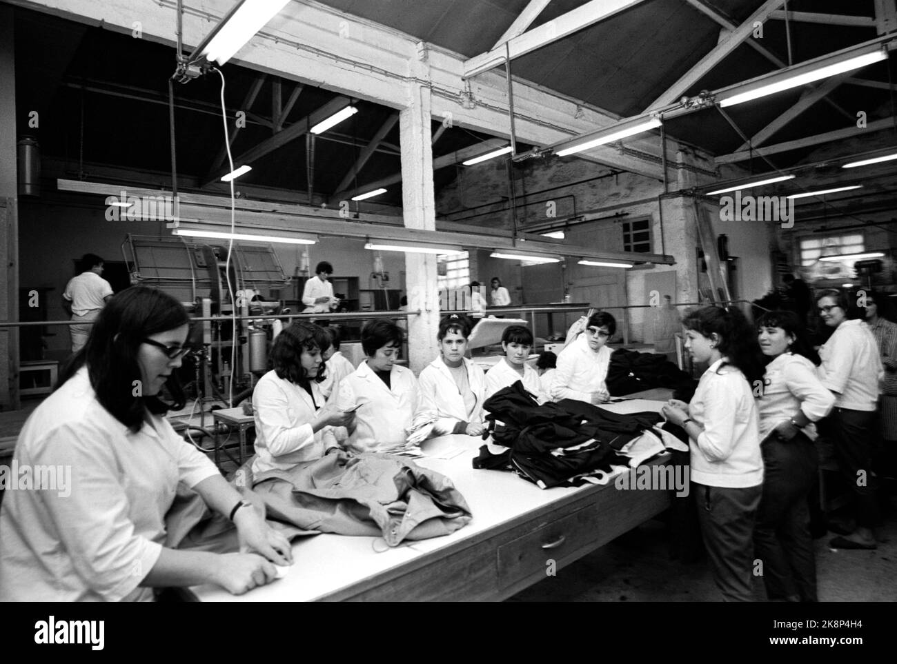 Portugal May 1968 Current visits two Norwegian companies in Portugal. Here, among other things, 14-15 year old girls in the factories for 5 kr. pr. day. There is no trade union, no three weeks of vacation, strikes are prohibited. The factories are established by Norwegian business people. This is from the Luso-Norte confection factory. The factory has Norwegian management. 100 women and teens in work in their uniforms in the large sysal. They have 9.5 hours of working day. Photo: Ivar Aaserud / Current / NTB Stock Photo