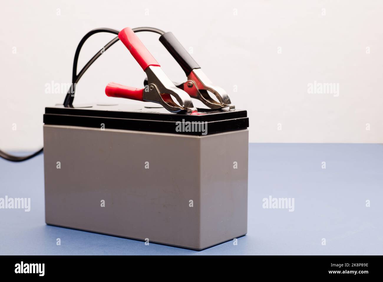connected bolts charging battery positive pole and negative pole, white
