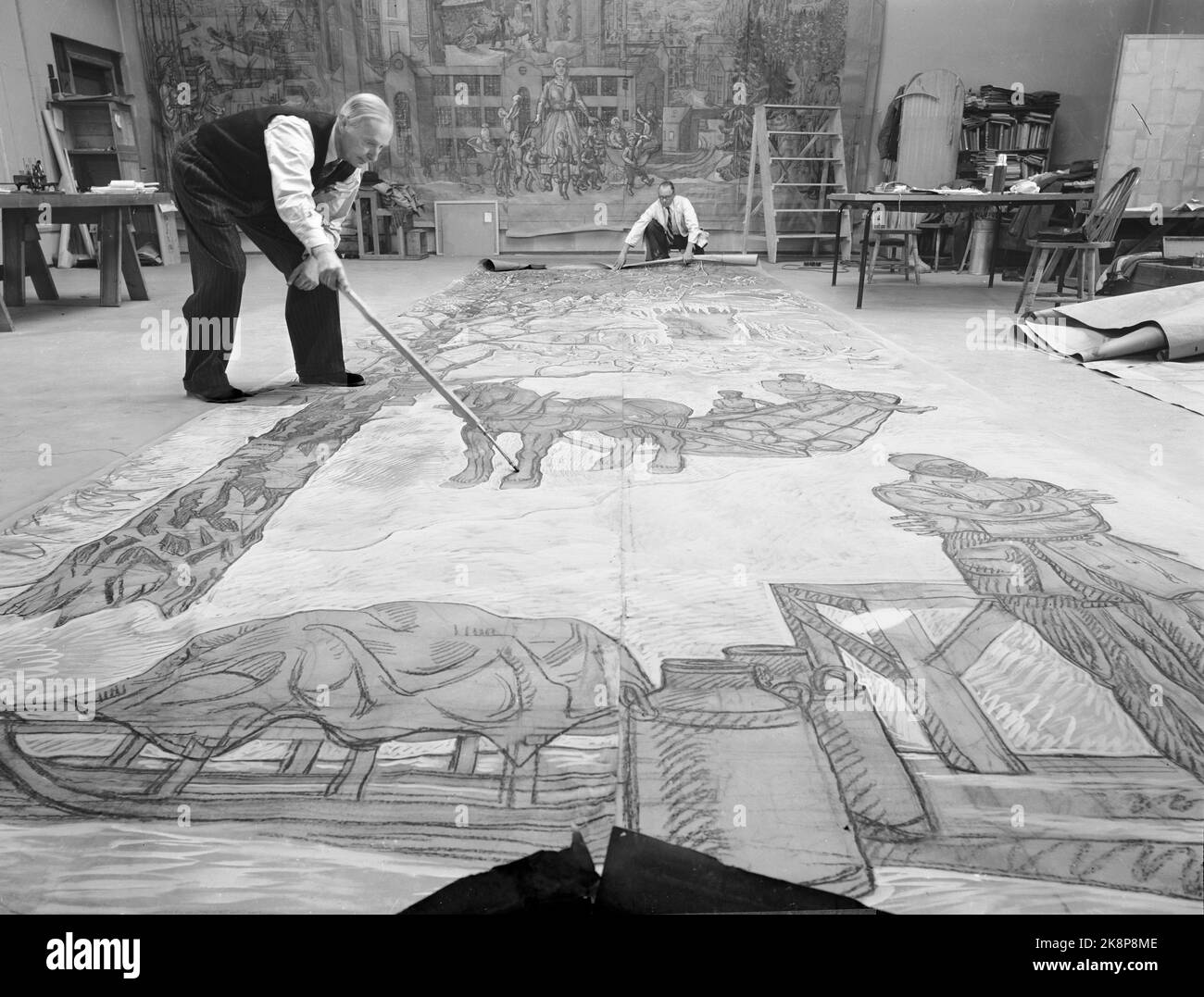 Oslo 195012. The artist Per Krohg has been given the honorable assignment to take care of the interior and artistic design of the security council's meeting room in the UN. The Ministry of Foreign Affairs has allocated money for the work that is a gift from Norway. Here we see Per Krohg while working on the painting in a studio in the town hall. The finished oil painting will measure 5.48 x 8.84 meters. Photo: Current / NTB Stock Photo