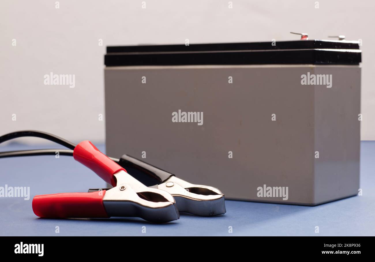 connected bolts charging battery positive pole and negative pole, white