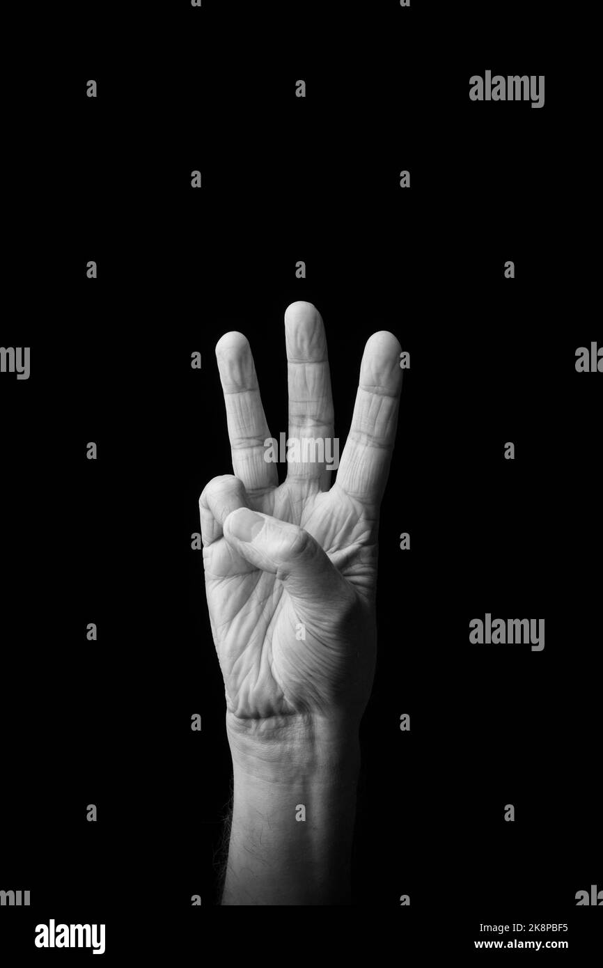 Dramatic black and white image of a male hand fingerspelling the ...