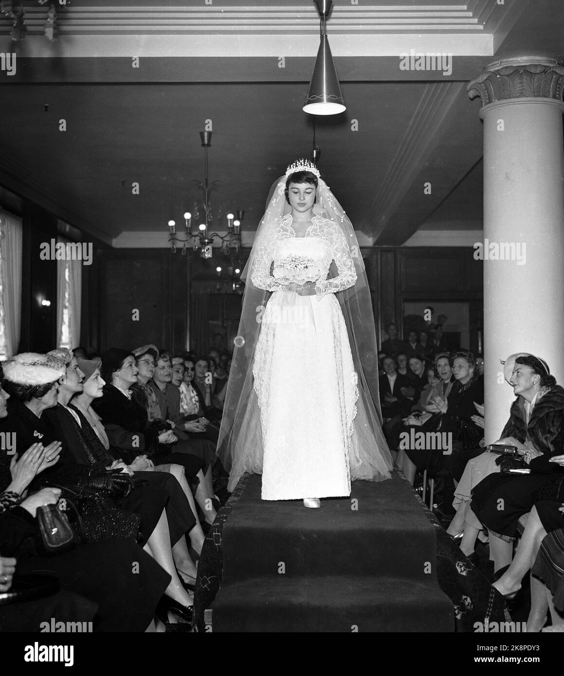 Oslo 19560321: Fashion view in Steen and Strøm magazine. Here the wedding dress. (The ladies who note in the first row th. May be fashion journalists. Photo: NTB Stock Photo