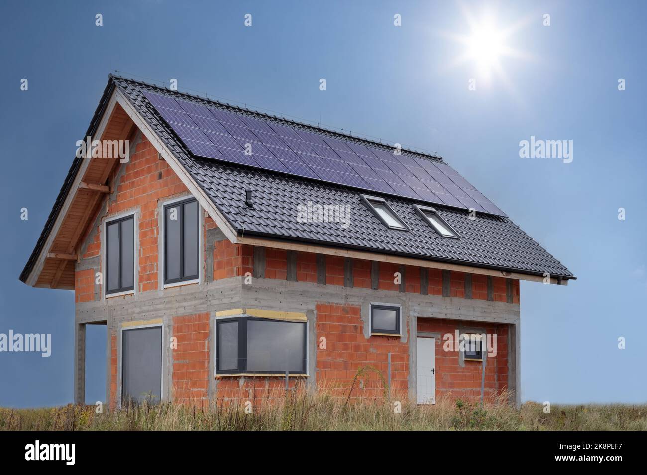 Solar panels on a newly built house, shell. Stock Photo