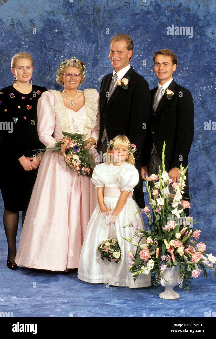 Oslo 19891209: Cathrine Ferner, grandson of King Olav, marries Arild Johansen in Ris church in Oslo. The bride in pink dress with sequins, lace and flower wreath in the hair. Here the bridal couple photographed with the grooms, Benedikte Ferner and Petter Elind. In the picture also the bridal girl, Laila Maria, the groom's 5 And half a year old niece. Photo: Knut Falch Stock Photo