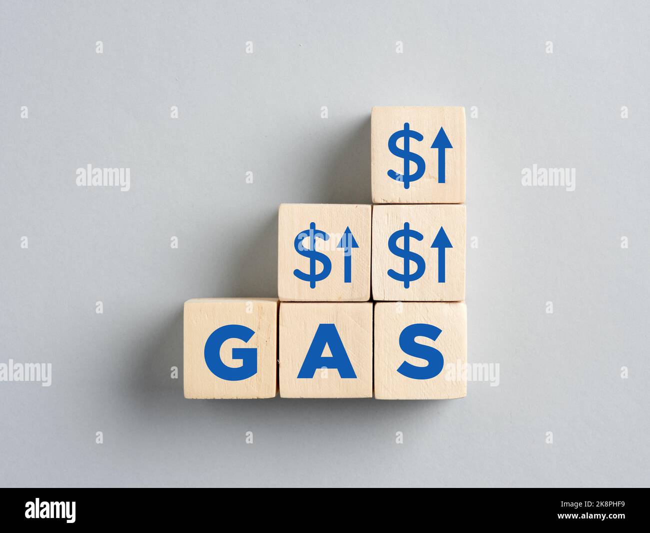 Rising or increasing gas prices. Energy crisis and economic sanctions. Wooden cubes with rising arrows and dollar signs with the word gas. Stock Photo