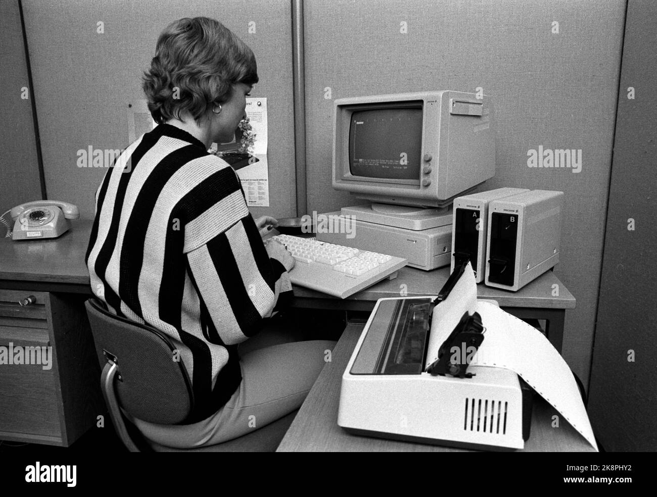 Oslo 19830520 Woman in work by computer in office. Computer, floppy disk drive, printer and gray phone in the picture. Photo: NTB / NTB Stock Photo